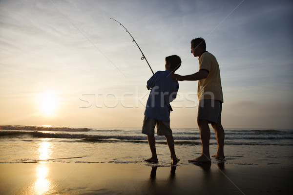 Man and young boy fishing in surf Stock photo © iofoto
