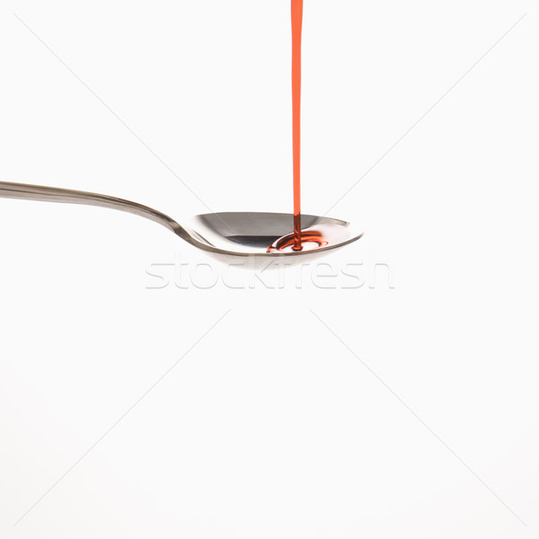 Stock photo: Spoon and red medicine.