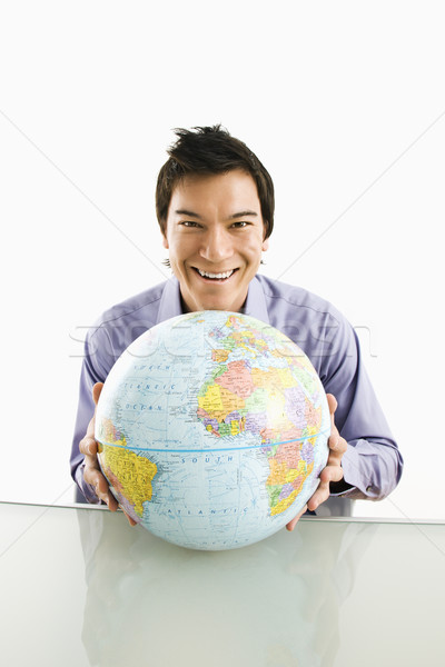 Homem globo jovem asiático sessão Foto stock © iofoto