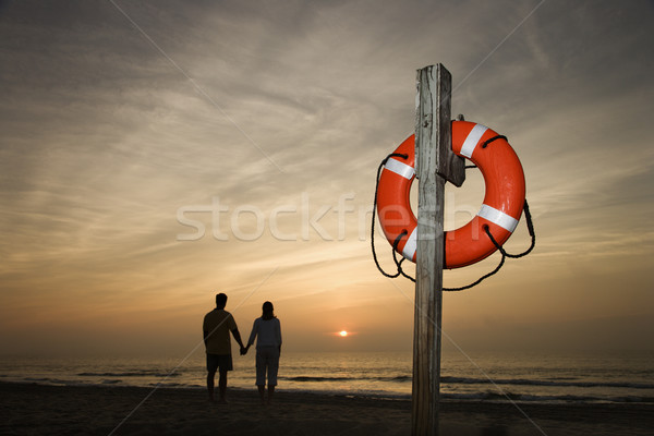 Couple holding hands on beach Stock photo © iofoto