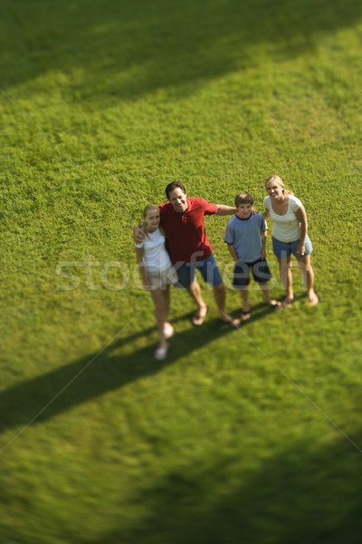 Family standing on lawn. Stock photo © iofoto