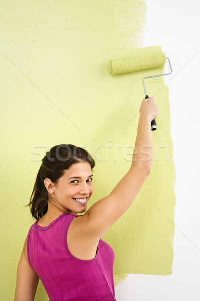 Stock photo: Smiling woman painting.