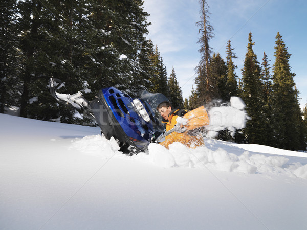 Man with stuck snowmobile. Stock photo © iofoto