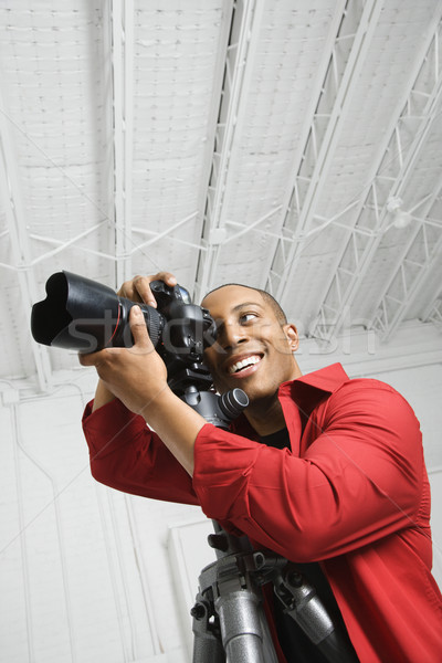 Stock photo: Photographer looking through camera.