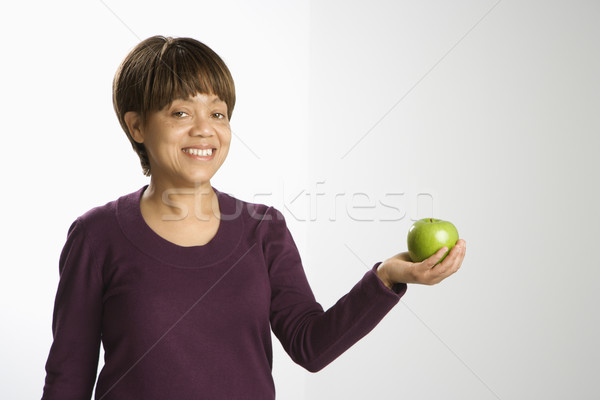 Woman holding apple. Stock photo © iofoto