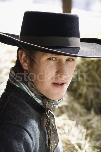 Vonzó fiatalember visel fekete cowboykalap széna Stock fotó © iofoto