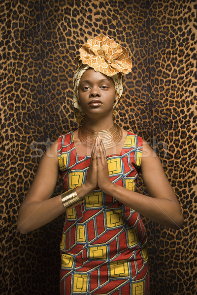 Young African American Woman Praying and Wearing Traditional African Dress Stock photo © iofoto