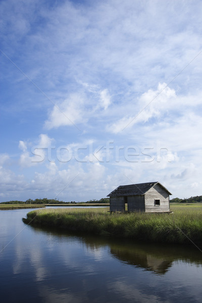 Weathered building on marshy creek. Stock photo © iofoto