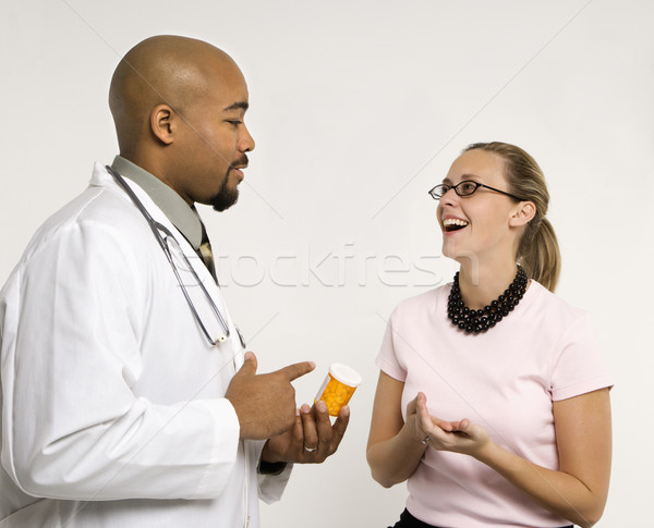 Doctor prescribing medication. Stock photo © iofoto