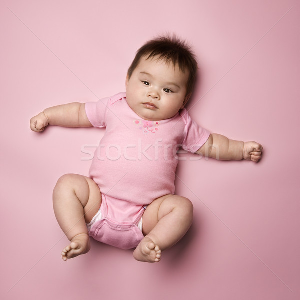 Stock photo: Baby lying on back.