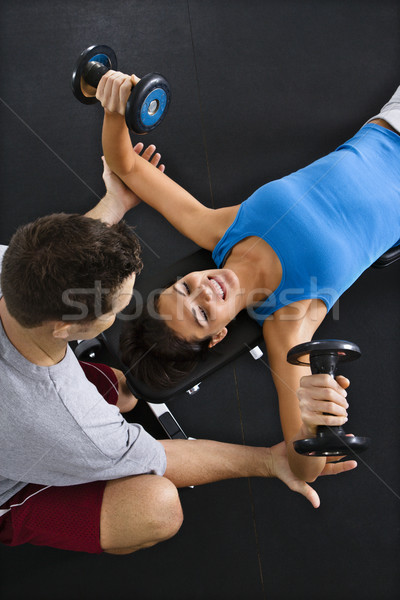 Woman lifting weights Stock photo © iofoto