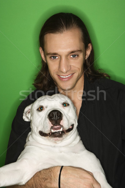 Man holding white dog on lap. Stock photo © iofoto