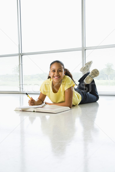 Girl doing schoolwork. Stock photo © iofoto