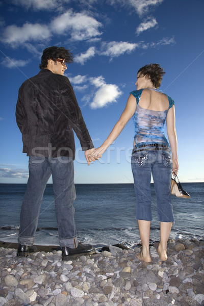 Couple mains tenant plage vue arrière permanent [[stock_photo]] © iofoto