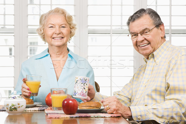 Mature couple eating breakfast. Stock photo © iofoto