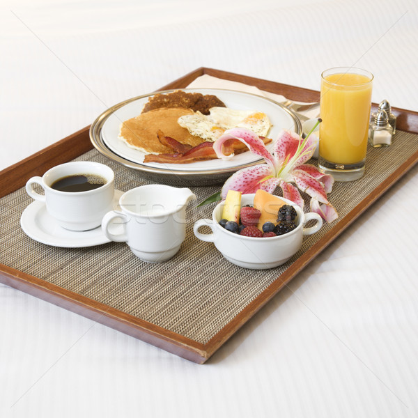 Stock photo: Breakfast tray on white bed.