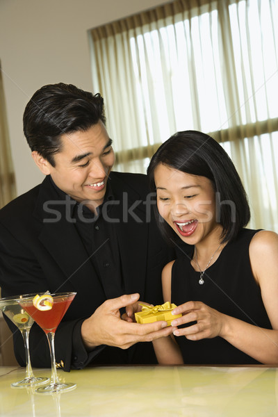 Stock photo: Attractive Young Man Giving Gift to Woman