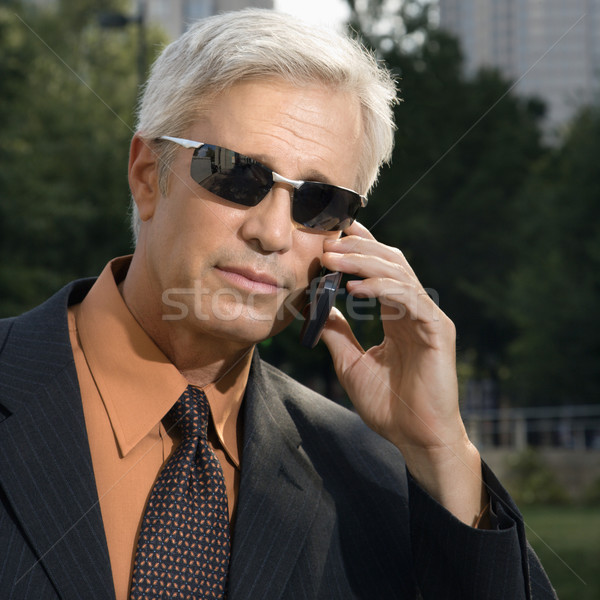 Businessman on cell phone. Stock photo © iofoto