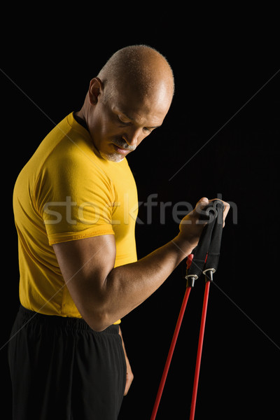 Man using exercise equipment. Stock photo © iofoto