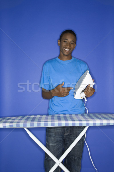 Teenage boy ironing. Stock photo © iofoto