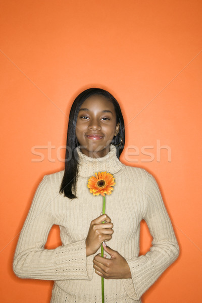 Teen girl holding flower. Stock photo © iofoto