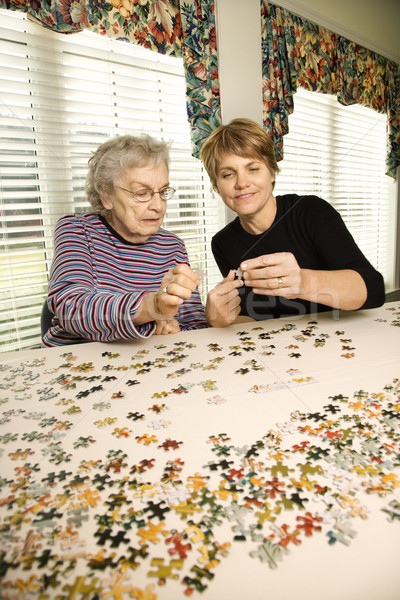 Idős nő nő munka kirakós játék együtt függőleges Stock fotó © iofoto