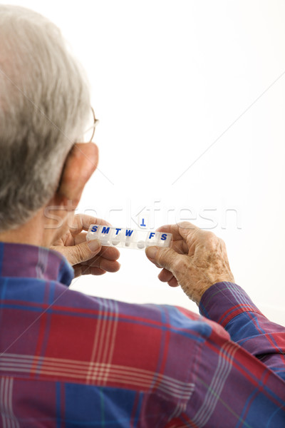 Man holding pill organizer. Stock photo © iofoto