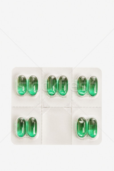 Pakiet kapsułka pigułki odizolowany zielone indywidualny Zdjęcia stock © iofoto