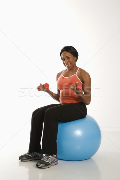 Stock photo: Woman exercising with ball.