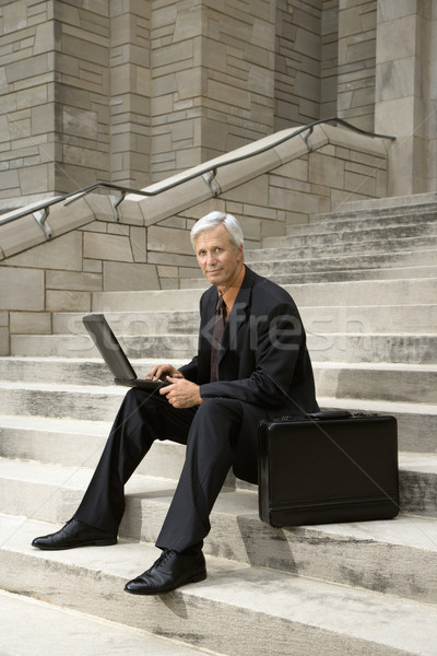 Businessman working outdoors. Stock photo © iofoto