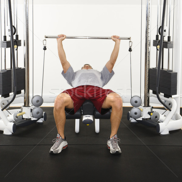 Adam ağırlıklar spor salonu ağırlık makine Stok fotoğraf © iofoto