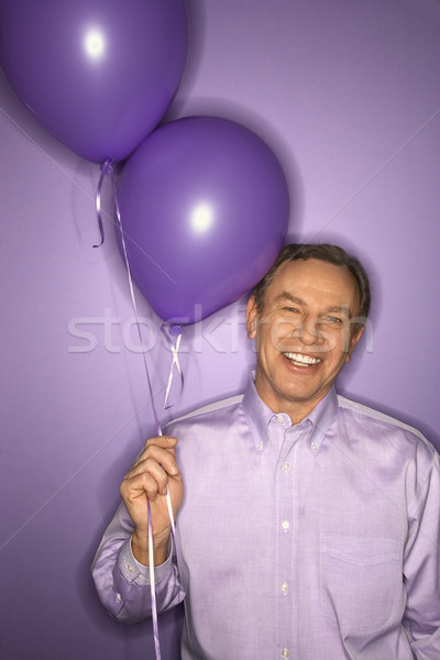 Man holding balloons. Stock photo © iofoto