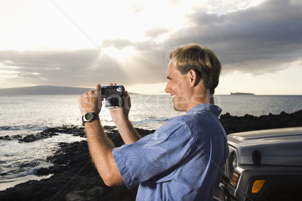 Man Using Video Camera at the Beach Stock photo © iofoto
