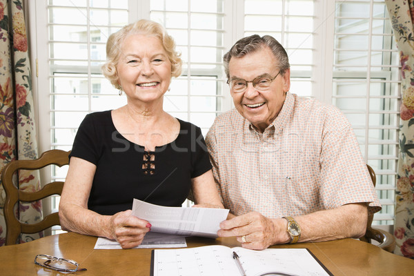 Mature couple with bills. Stock photo © iofoto