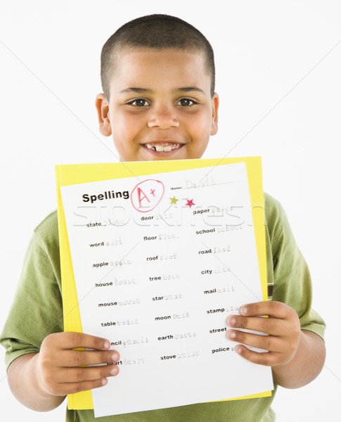 Smiling hispanic boy holding homework. Stock photo © iofoto