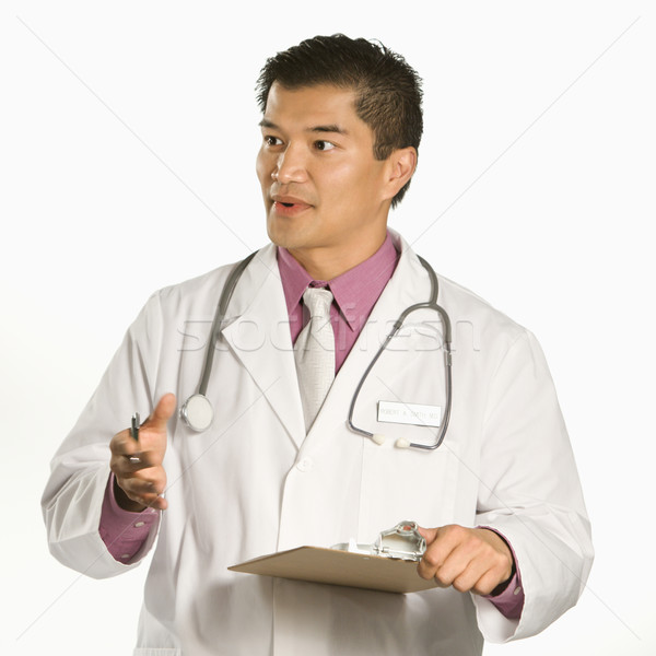 Médecin de sexe masculin asian presse-papiers parler [[stock_photo]] © iofoto