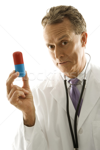 Stock photo: Doctor with large pill.