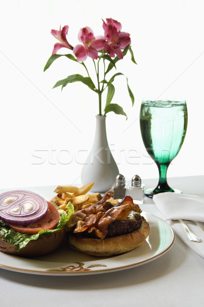 Cheeseburger flori masă sticlă apă faţă Imagine de stoc © iofoto