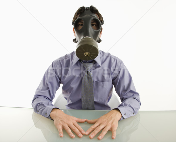 Uomo indossare maschera antigas imprenditore seduta bianco Foto d'archivio © iofoto