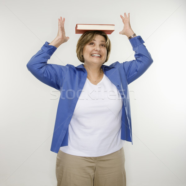 Woman balancing book. Stock photo © iofoto