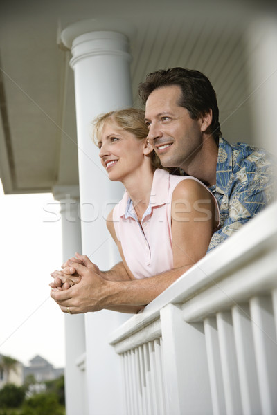Boldog pár veranda otthon mosolyog férfi Stock fotó © iofoto