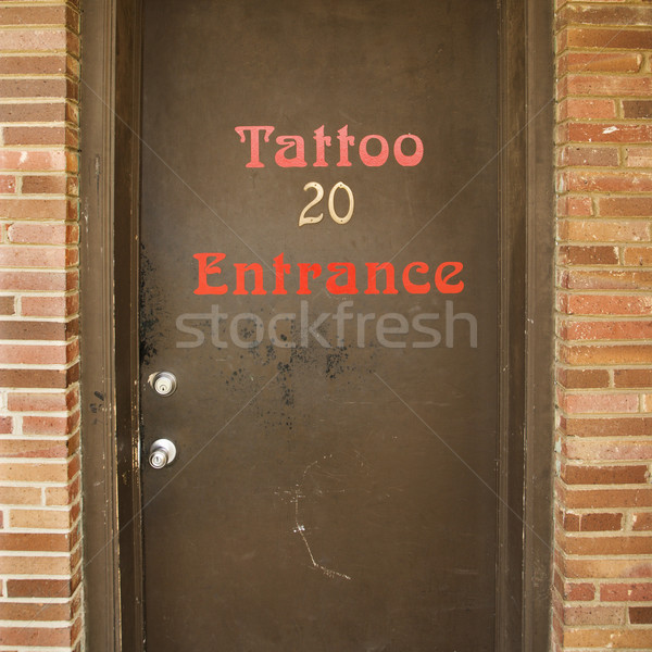 Stock photo: Door to tattoo parlor.