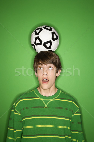 Boy balancing soccer ball. Stock photo © iofoto