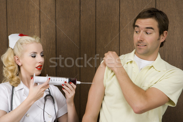 Nurse giving man shot. Stock photo © iofoto