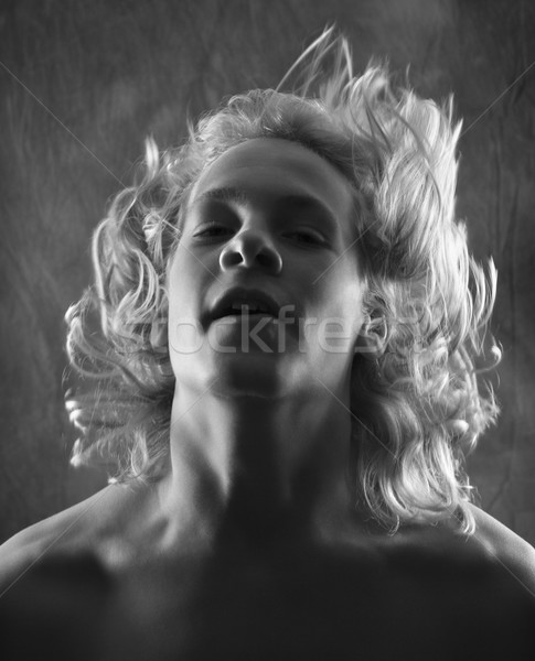 Teen boy flipping hair back. Stock photo © iofoto