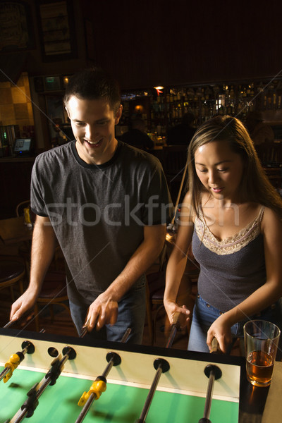 Couple playing foosball. Stock photo © iofoto