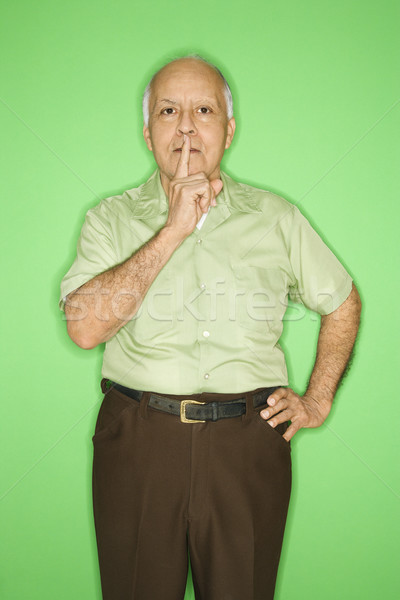 Man with finger up to mouth. Stock photo © iofoto