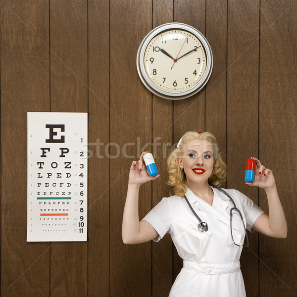 Retro nurse with medicine. Stock photo © iofoto