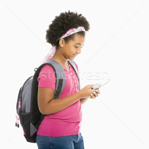 Iskolás lány telefon afroamerikai lány hátizsák sms üzenetküldés Stock fotó © iofoto