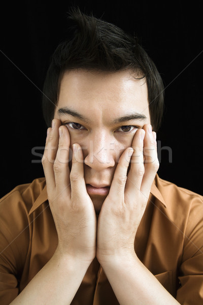 Człowiek ręce twarz portret asian młody człowiek Zdjęcia stock © iofoto